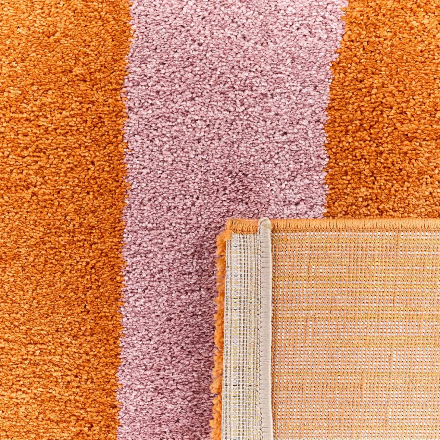 Indoor rug with orange and pink stripes