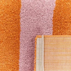 Indoor rug with orange and pink stripes