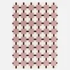 Indoor rug with pink and brown checkered pattern