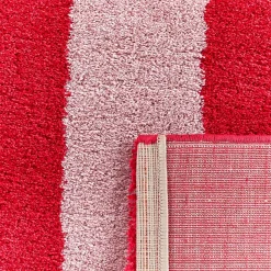 Indoor rug with red and pink stripes