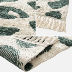 Interior cotton rug with dark green speckled pattern and fringes