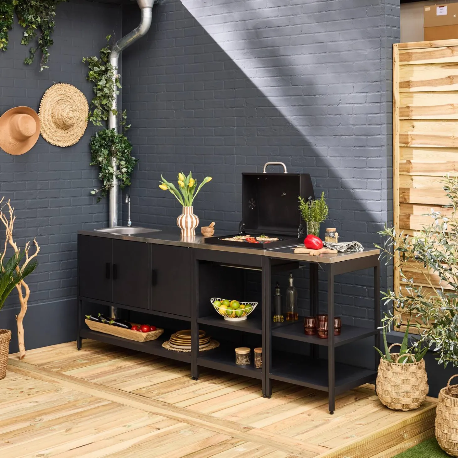 Outdoor kitchen with charcoal barbecue and 3 modules with sink