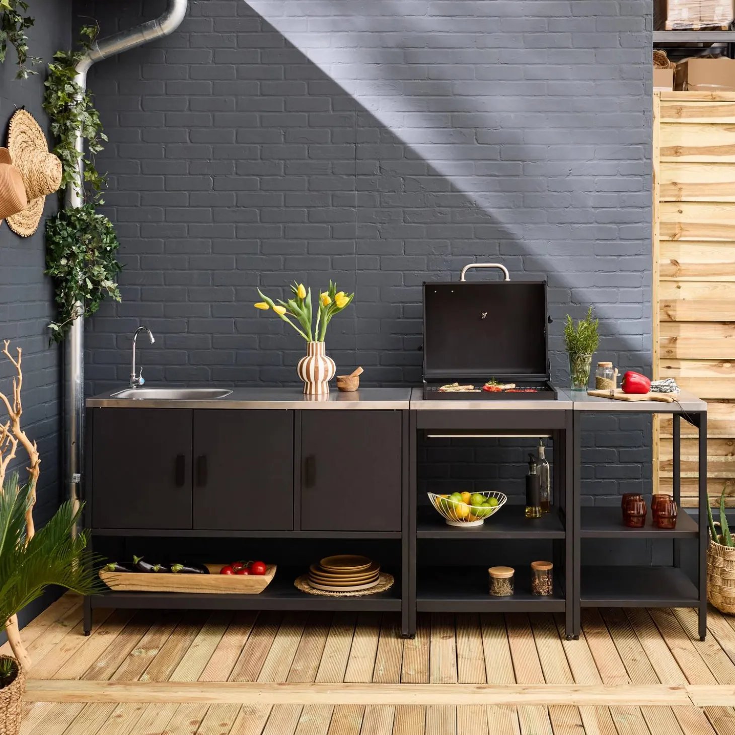 Outdoor kitchen with charcoal barbecue and 3 modules with sink