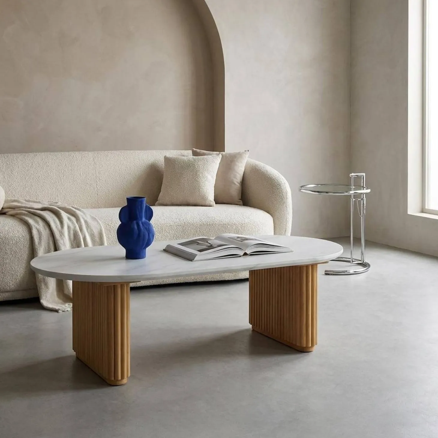 Oval coffee table in rubberwood with stone effect veneer
