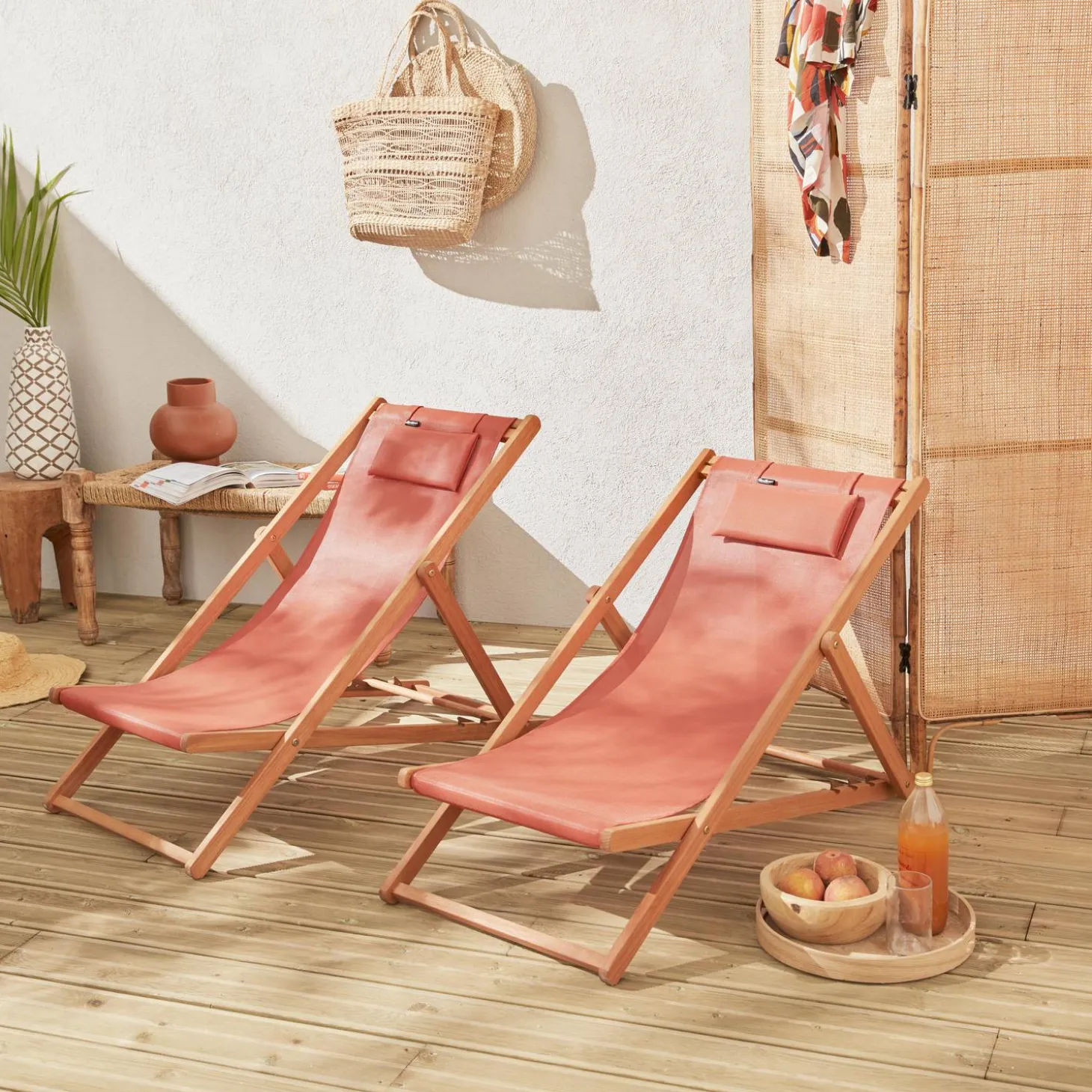 Pair of eucalyptus deck chairs with headrest cushions