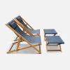 Pair of wooden deckchairs and footrests