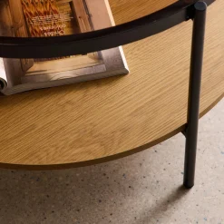Round coffee table with double glass top, wood decor and metal