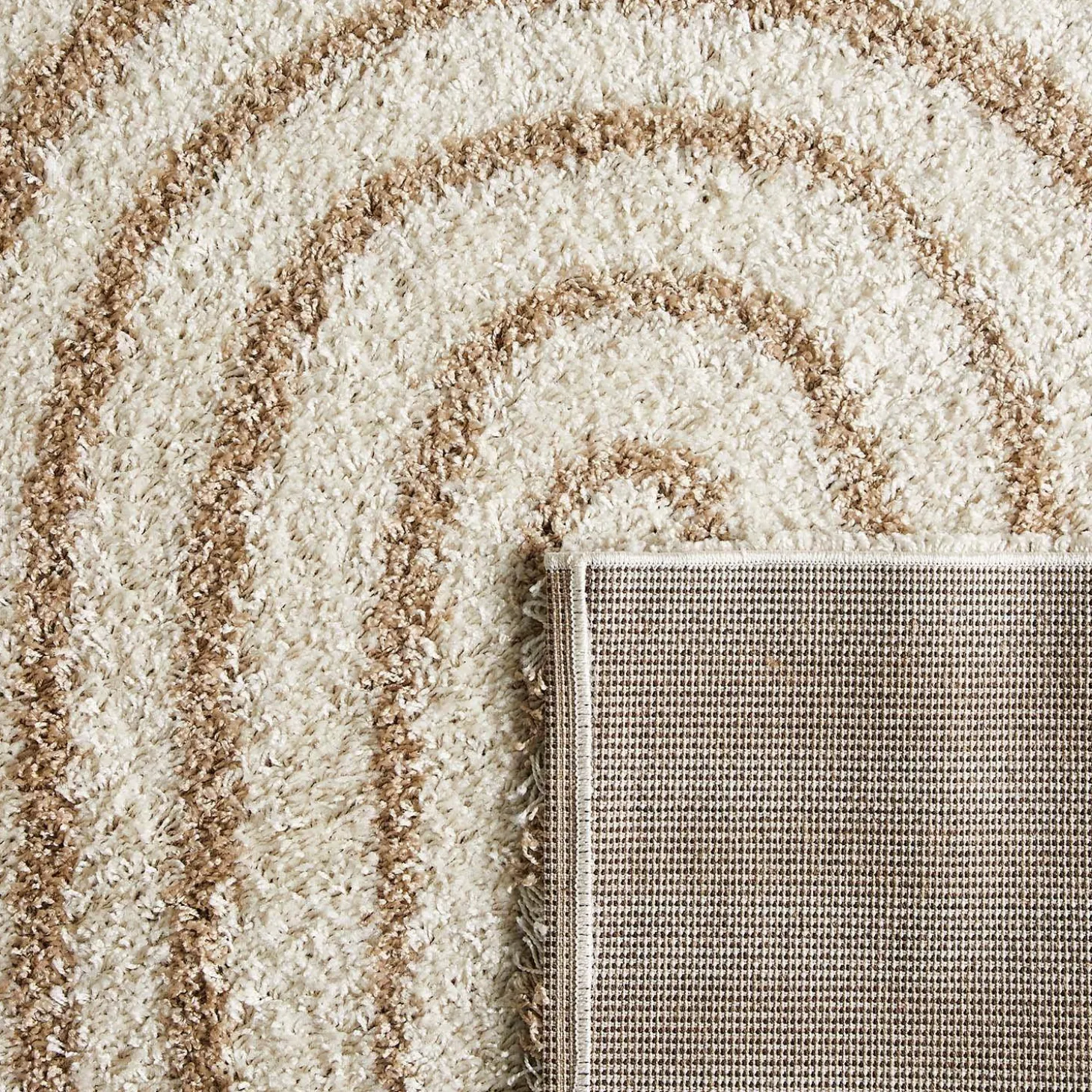 Shaggy indoor rug, rainbow geometric patterns, beige.