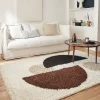 Shaggy indoor rug with circular patterns in beige, brown, black