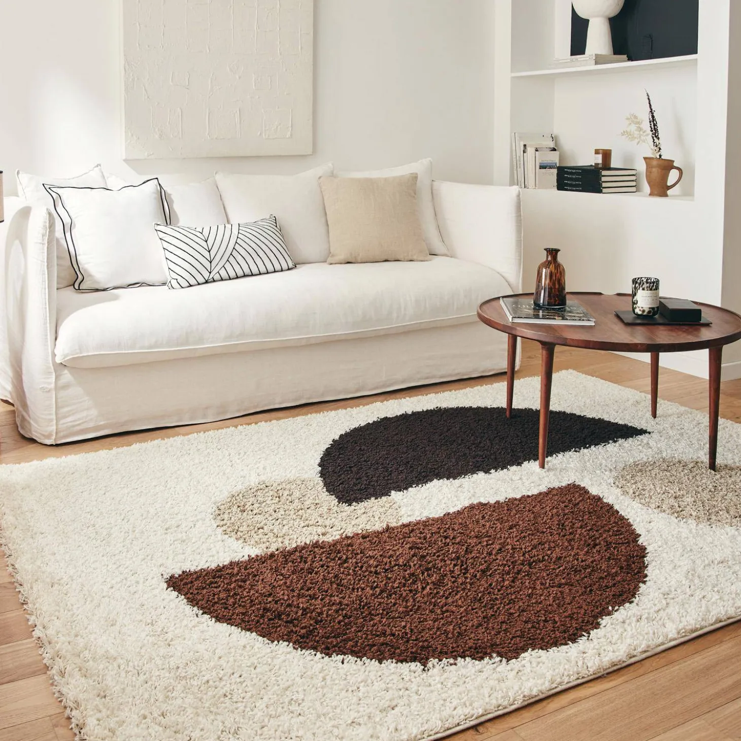 Shaggy indoor rug with circular patterns in beige, brown, black