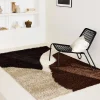 Shaggy indoor rug with geometric patterns in beige, brown and black