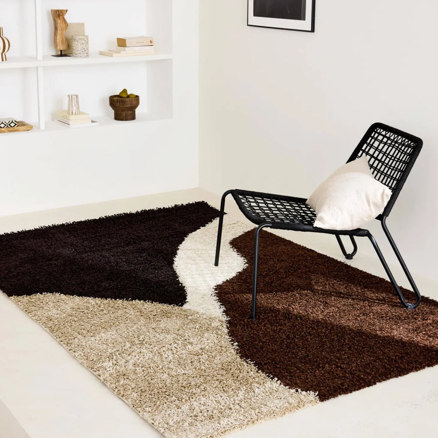 Shaggy indoor rug with geometric patterns in beige, brown and black